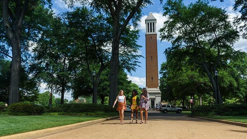 Students walk in front of Denny Chimes.